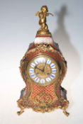 Ornate gilt metal French boule clock with cherub finial, 46cm.