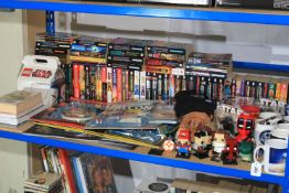 Collection of Star Wars memorabilia including Millennium Falcon kit, books, action figure, etc.