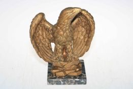 Gilt metal eagle on marble base, 25cm high.