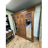 Victorian carved walnut combination wardrobe having two central cupboard doors above five drawers
