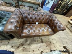 Tan buttoned leather and studded two seater Chesterfield settee.