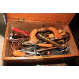 Oak tool chest containing vintage tools including brace, planes, spoke shaves, chisels, etc.