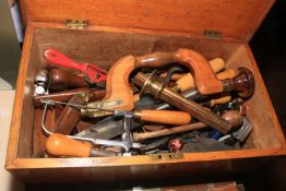 Oak tool chest containing vintage tools including brace, planes, spoke shaves, chisels, etc.
