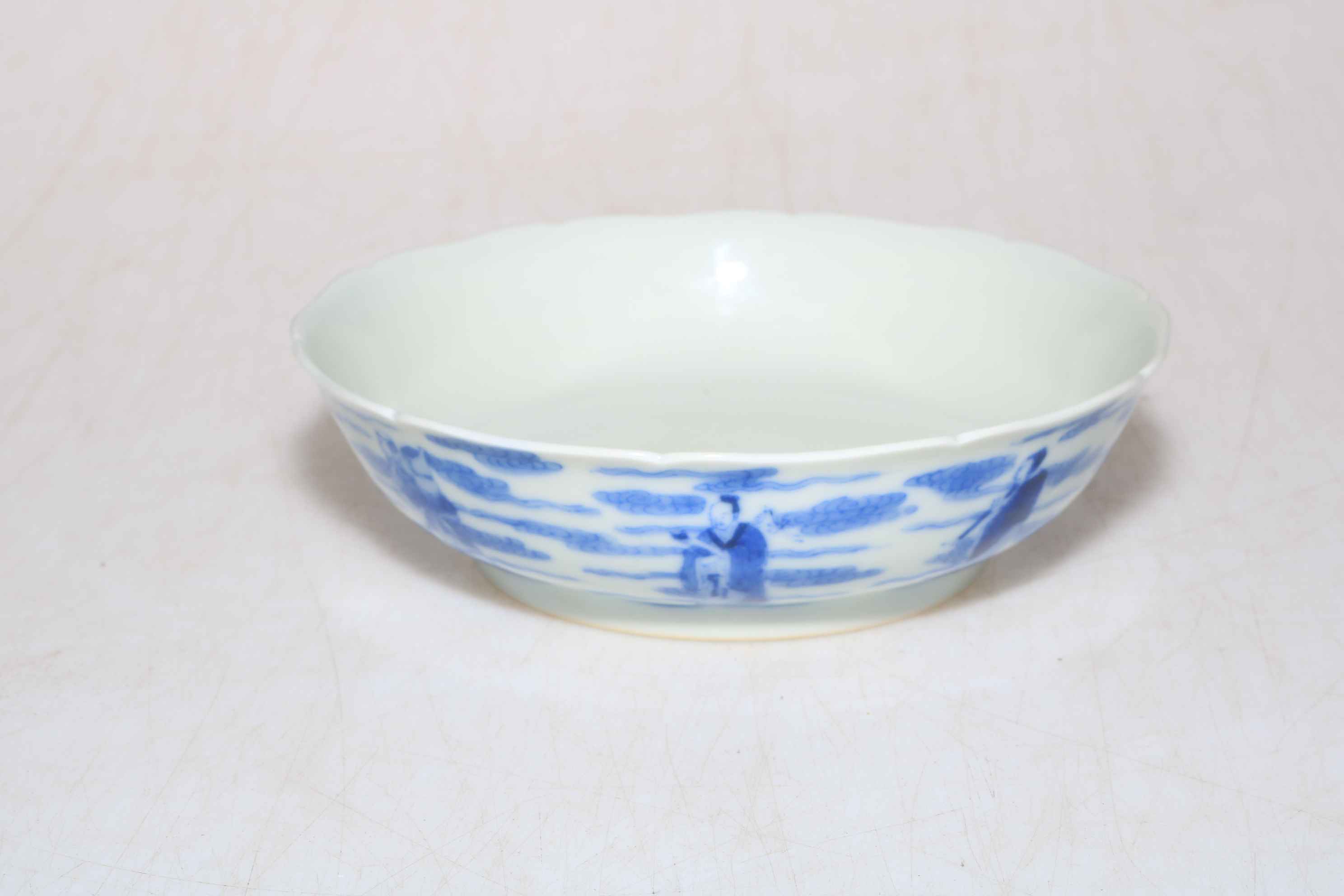 Blue and white Chinese shallow dish decorated with a series of figures, Kangxhi mark to base,