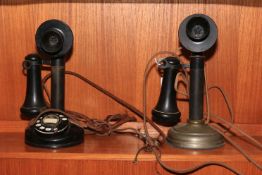 Two vintage candlestick telephones.
