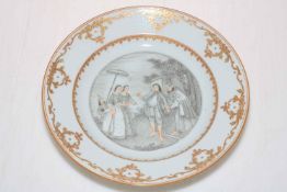 Polychrome plate decorated with Oriental figures and gilt border, 22cm diameter.