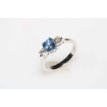 Ceylon sapphire and diamond three stone ring set in 18 carat white gold, size O.