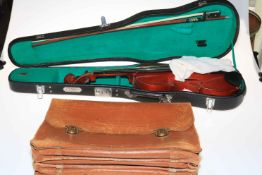 Cased violin and bow and music briefcase.
