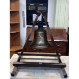 Brass ships bell mounted in triangular frame, 72.5cm by 61cm by 59cm.