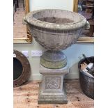 Large weathered garden urn on pedestal stand, 102cm by 62cm diameter.