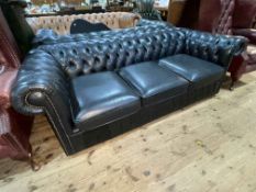 Black buttoned leather and studded three seater Chesterfield settee.