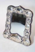 Ornate pierced and embossed silver mirror.