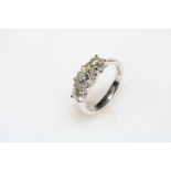 Three stone diamond ring set in 18 carat white gold, total diamond weight 1.