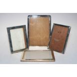 Collection of four silver photograph frames.