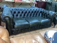 Green buttoned leather and studded three seater Chesterfield settee.