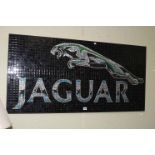 Glass mosaic on panel of Jaguar Trademark, 61cm by 123cm.