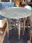 Eastern circular brass topped folding coffee table, 56cm by 59.5cm diameter.