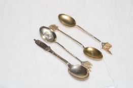 Four commemorative silver spoons.