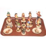 Thirteen Hummel figurines and two Hummel plates.