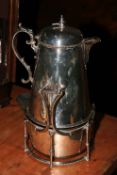 Large silver plated pitcher on stand.