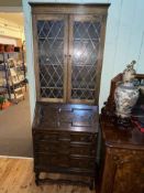 1920's oak bureau bookcase having two leaded glass doors above a fall front with three drawers