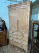 Victorian pine press having two panelled doors above two short and three long drawers,