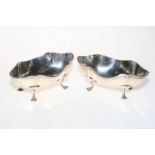 Pair of shaped silver bon bon dishes, each raised on four paw feet, Birmingham 1926.