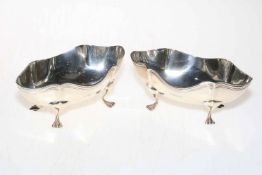 Pair of shaped silver bon bon dishes, each raised on four paw feet, Birmingham 1926.