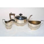 A silver three piece part fluted tea set, Birmingham 1911.