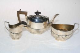 A silver three piece part fluted tea set, Birmingham 1911.