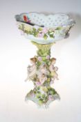 Large floral encrusted and cherub table centre piece, 41cm high.