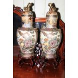 Pair of Oriental vases, covers and stand, 78cm high.