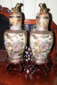 Pair of Oriental vases, covers and stand, 78cm high.