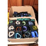 Two boxes of beadwork necklaces and bracelets.