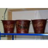 Three buckets marked Coca Cola.