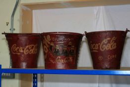 Three buckets marked Coca Cola.