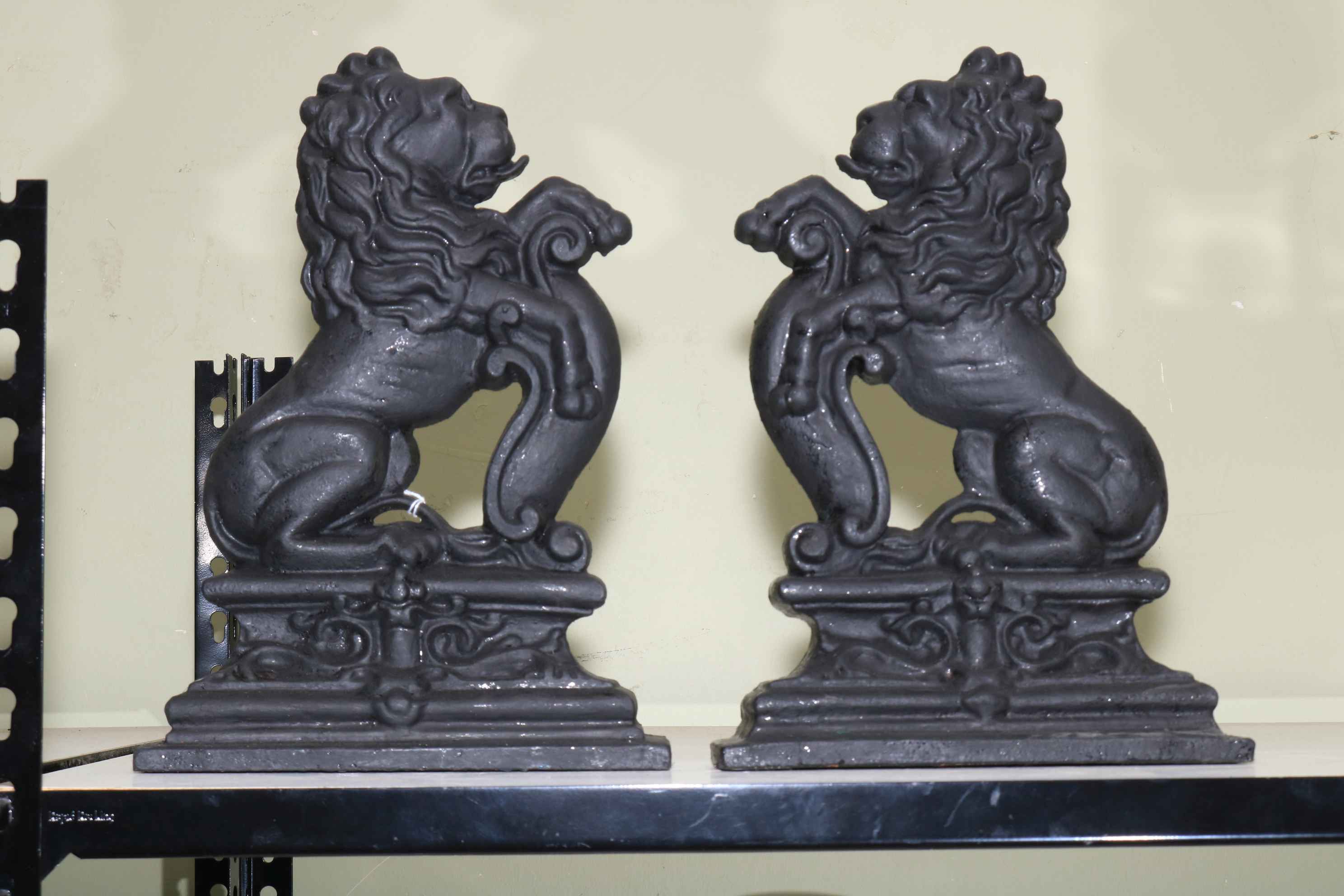 Pair of cast iron lion doorstop's, 36cm high.