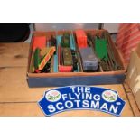 Collection of train carriages and track, together with cast iron The Flying Scotsman sign.