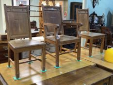 Set of three gold oak ecclesiastical panel back chairs (one arm and two single).