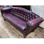 Victorian mahogany framed settee in deep buttoned ox blood leather.
