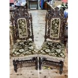 Pair Victorian carved oak side chairs with armorial crests.