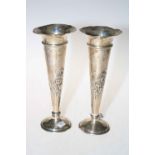 Pair of Edwardian heavily loaded silver vases with embossed decoration, London 1908.