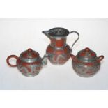 Chinese Yixing Earthen Ware tea set with silvered design overlay.