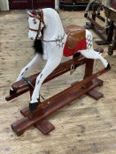 Partial sponge painted wooden rocking horse on safety stand, 106cm by 124cm.