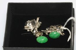 Pair ornate jade earrings.