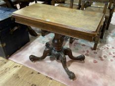 Victorian walnut fold top card table on carved pedestal to four scrolled legs,