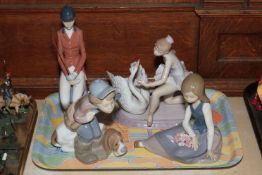 Four Lladro figure comprising Ballerina and Swan, Boy with Gun and Dog,