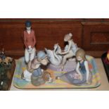 Four Lladro figure comprising Ballerina and Swan, Boy with Gun and Dog,