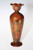 Linthorpe Pottery slim bodied vase with floral design on brown ground, number 1755.