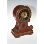 Vintage mahogany Art Nouveau balloon clock with fish decoration, 37cm high.